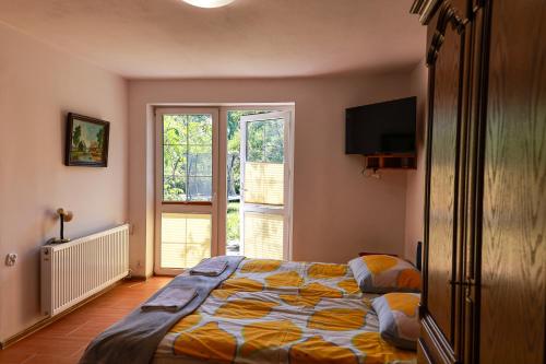 a bedroom with a bed and a large window at PSZCZÓŁKA in Białogóra