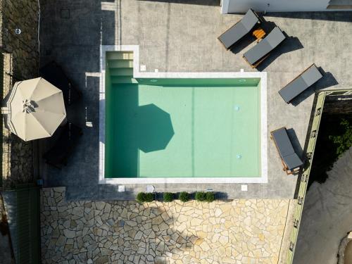 an overhead view of a swimming pool with an umbrella at Vasilopoulos Residences - Villa Kalliste in Argostoli