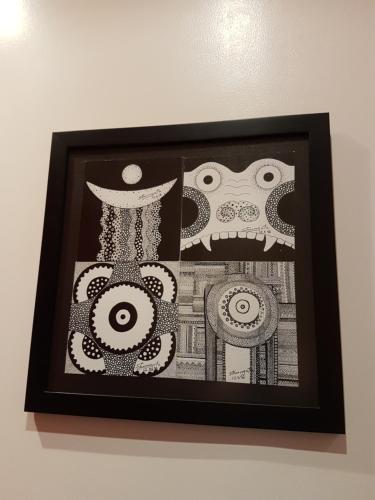 a black and white picture of a painting on a wall at Casa 24 Puerto Iguazu in Puerto Iguazú