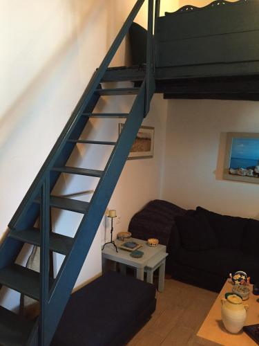 a blue staircase in a living room with a couch at House on the beach in Skiros
