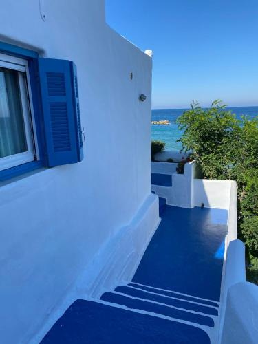 a stairway leading up to a building with the ocean at House on the beach in Skiros