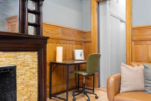 a room with a desk and a chair and a fireplace at Vintage Luxe NY - Designer Lofts & Apartments NYC in New York