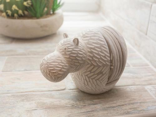 a small wooden animal figurine sitting on a floor at Hippo's Rest in Mow Cop