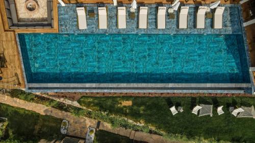 an overhead view of a swimming pool with chairs at Vista Del Amor Faralya in Fethiye