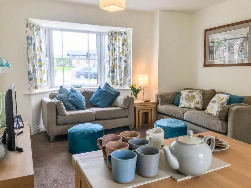 a living room with a couch and a table at Arthur's Place in Reighton