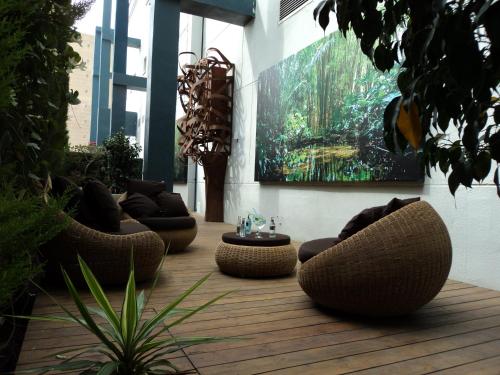
a living room filled with furniture and plants at Hotel Principal in Gandía
