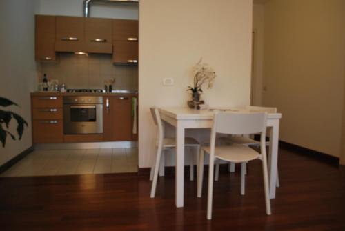 a kitchen with a white table and chairs in a room at Lovely Apartment Verona in Verona