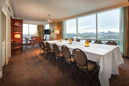 a conference room with a long table and chairs at Hilton Lac-Leamy in Gatineau