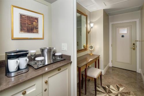 a kitchen with a counter and a table and a mirror at Hilton Lac-Leamy in Gatineau