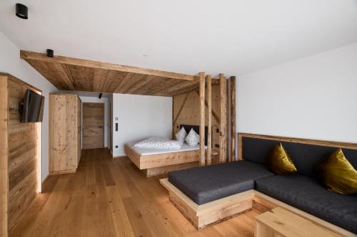 a living room with a couch and a bed at Lanzenschuster in San Genesio Atesino
