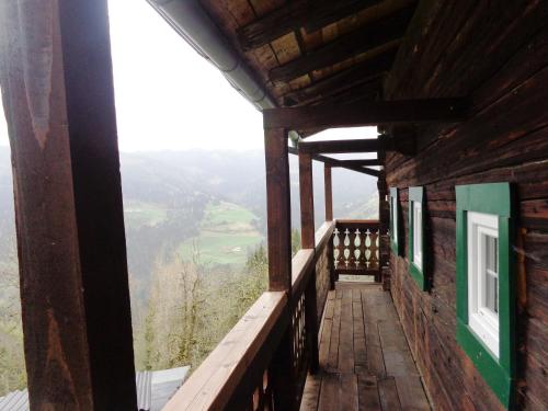 a balcony of a cabin with a view of a valley at Almhütte Brandgut in Mühlbach am Hochkönig