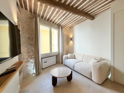 un salon avec un canapé blanc et une table dans l'établissement Luxe et Charme sur les Remparts du Vieil Antibes, à Antibes