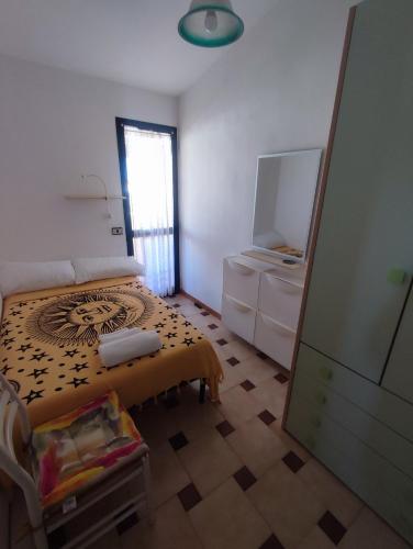 a bedroom with a bed and a television in it at Casa Rosanna in Porto Ottiolu