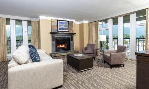 a living room with a couch and a fireplace at Hilton Whistler Resort & Spa in Whistler