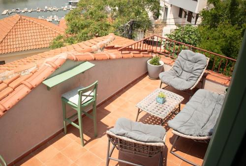a balcony with two chairs and a table and chairs at Theothea Suites in Kavala