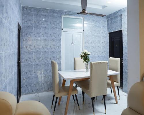 a dining room with a table and chairs at Monroe Luxury Apartments in Nsima