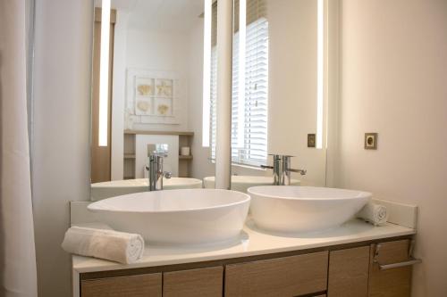 a bathroom with two sinks and a mirror at Comfortable villa with private pool in Grand-Baie