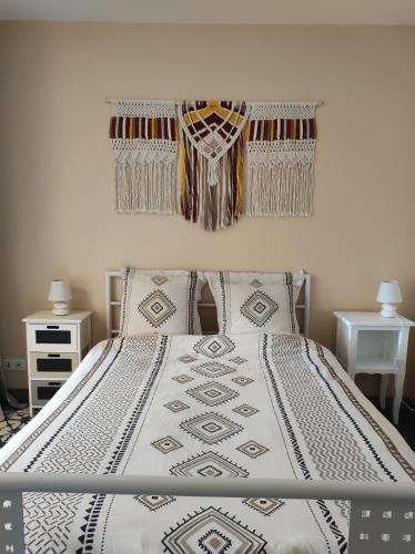 a bedroom with a bed with a blanket on it at l'Echappée Crançotine in Crançot