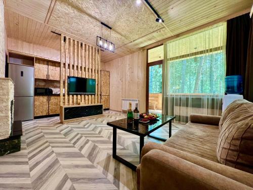 a living room with a couch and a table at Milenium magic villas on Sevan beach in Sevan