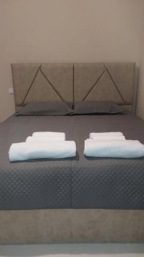 a bed with two white pillows on top of it at Tsikhisdziri Panorama Cottage in K'obulet'i