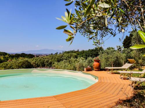 a swimming pool on a wooden deck next to a bench at Tuscan Farmhouse in the Countryside in Serravalle Pistoiese