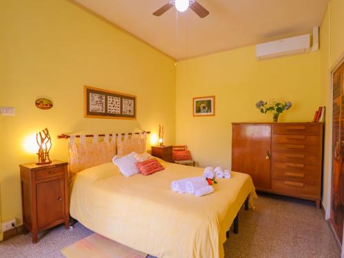 a bedroom with a bed with two towels on it at Tuscan Farmhouse in the Countryside in Serravalle Pistoiese