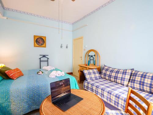 a living room with a couch and a laptop on a table at Tuscan Farmhouse in the Countryside in Serravalle Pistoiese