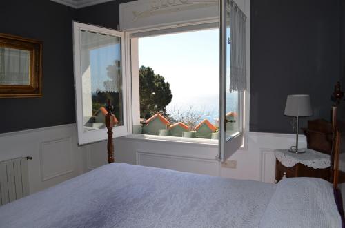 a bedroom with a bed and a large window at Villa Jordana Urbapol One Step To The Beach in San Pol de Mar