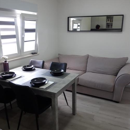 a living room with a table and a couch at Kika in Vrgorac