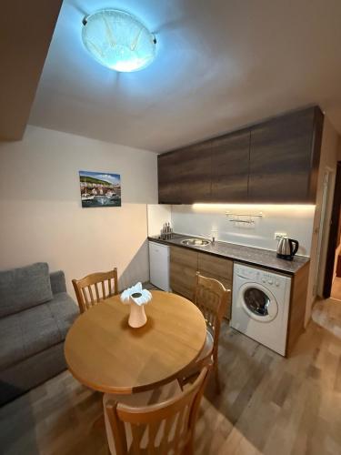 a kitchen with a table and a couch and a table and chairs at Casa Luba Sunny beach in Sunny Beach