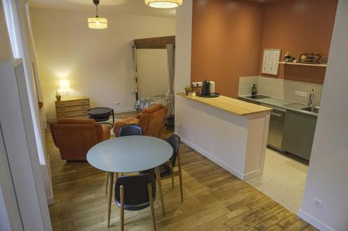 - une cuisine avec une table, une table et des chaises dans l'établissement Cocon lumineux au coeur du 18ème, à Paris
