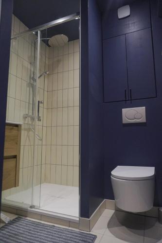 une salle de bain avec toilettes et douche en verre dans l'établissement Cocon lumineux au coeur du 18ème, à Paris