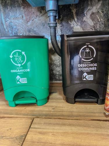 a green toaster and a television sitting on a floor at Watzara Wasi Dpt Familiar cerca de Cuicocha in Cotacachi