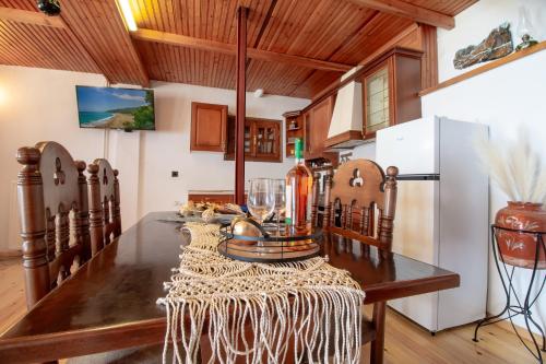 a kitchen with a wooden table and a refrigerator at Stamos Paradise View in Zagora