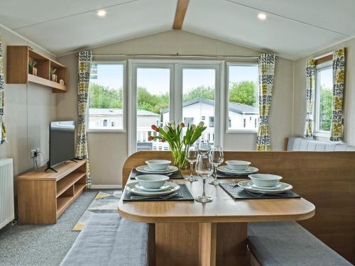 a dining room with a table with plates and glasses at Ocean Edge in Heysham