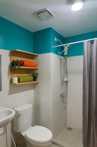 a bathroom with a toilet and a shower at Stylish Urban in Central Location with 500Mbps WiFi and Private Parking in Bacolod