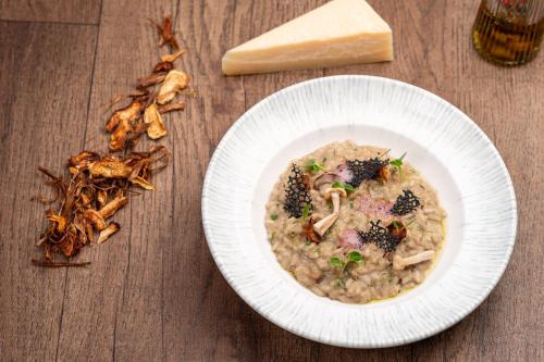 a bowl of food on a table with a plate of food at Holiday Inn Gurgaon NH8 by IHG in Gurgaon