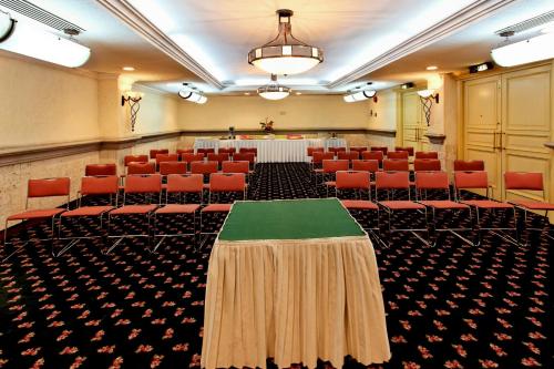 a conference room with red chairs and a table in it at Holiday Inn Queretaro Centro Historico by IHG in Querétaro