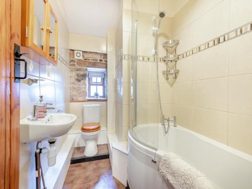 a bathroom with a sink and a tub and a toilet at Lord Mayors Barn in Alston