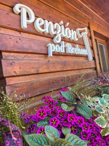 a sign for a pool botanical garden with purple flowers at Penzion pod Brehom in Terchová