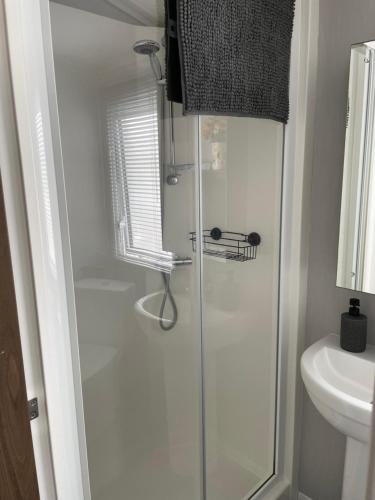 a bathroom with a shower and a sink at J4 Lossiemouth Bay Caravan Park in Lossiemouth