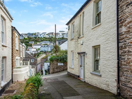 an alleyway between two buildings with a city in the background at Gypsett in Polruan