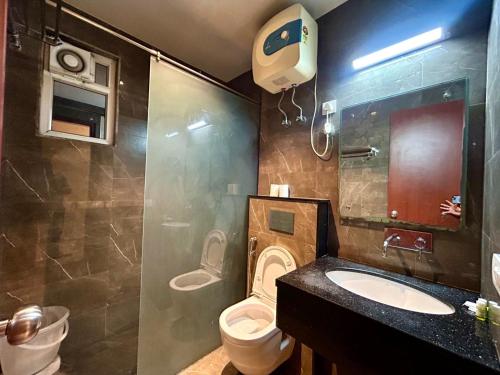 a bathroom with a toilet and a sink and a shower at Hotel Z Suites - Delhi Airport- FREE Airport Pickup & Drop in New Delhi