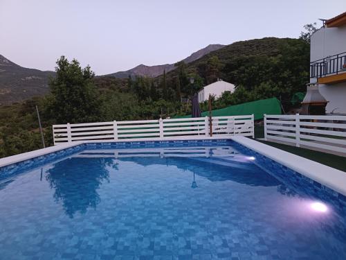 a large swimming pool with a white fence at Los Cabales in Torres