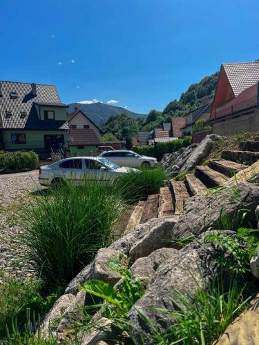 a car parked on a hill with some rocks at Penzion pod Brehom in Terchová