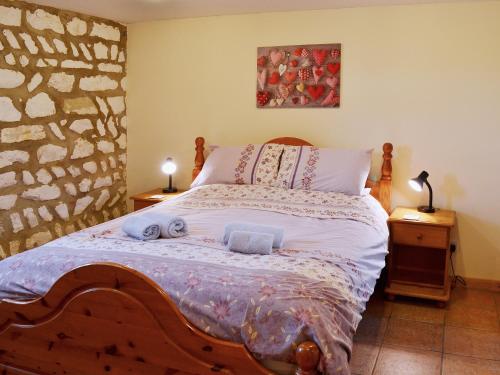 a bedroom with a bed with two towels on it at Kittiwake House in Flamborough