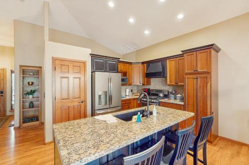 a kitchen with wooden cabinets and a granite counter top at Elk Run Escape in Show Low