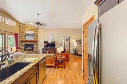 a kitchen and living room with a refrigerator at Elk Run Escape in Show Low