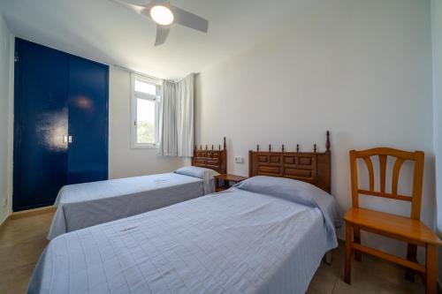 a bedroom with two beds and a window at Torrebaix in Torredembarra