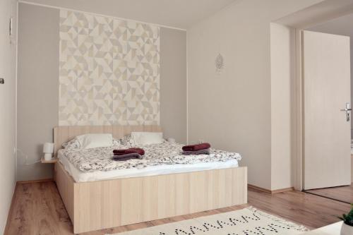 a bedroom with a large bed in a room at Csenár Apartman Hegykő in Hegykő